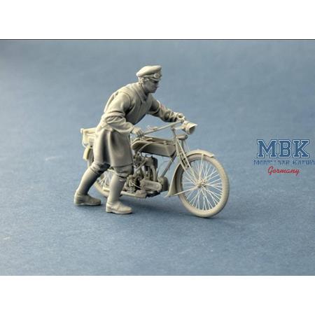 British Dispatch Rider pushing his motorcycle