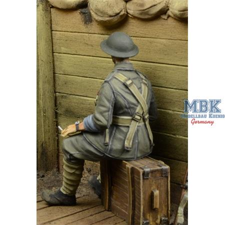 WWI British Infantryman sitting on a case