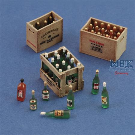 Champagne, cognac and wine bottles with crates